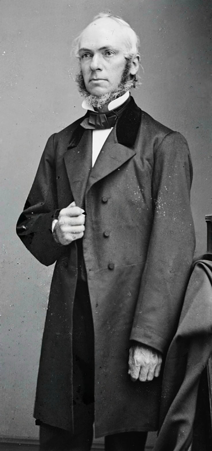 Nineteenth-century studio portrait of a standing bearded man in a dark frock coat, identified as Professor James Strong
